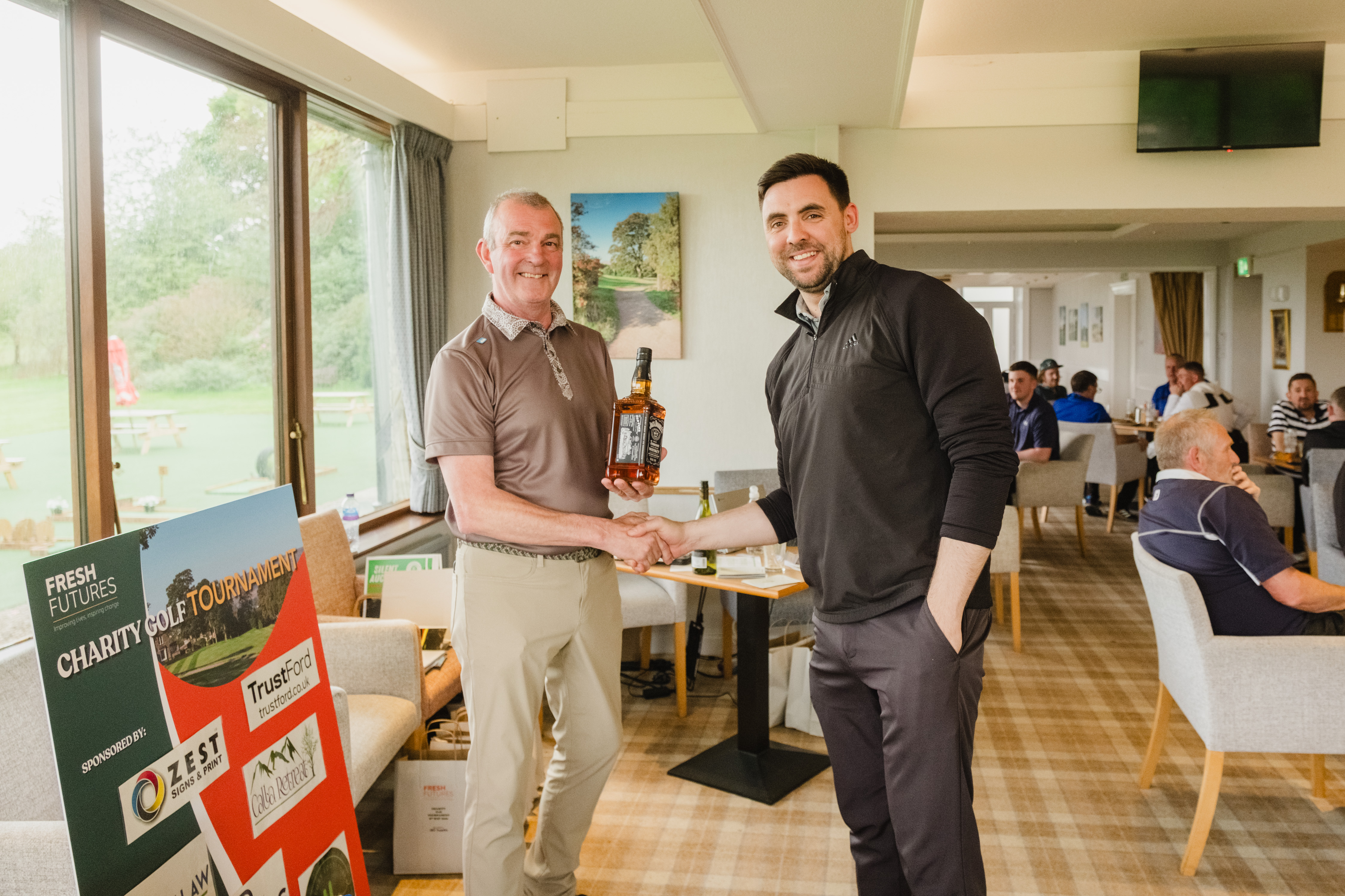 golf day promoter and player shaking hands