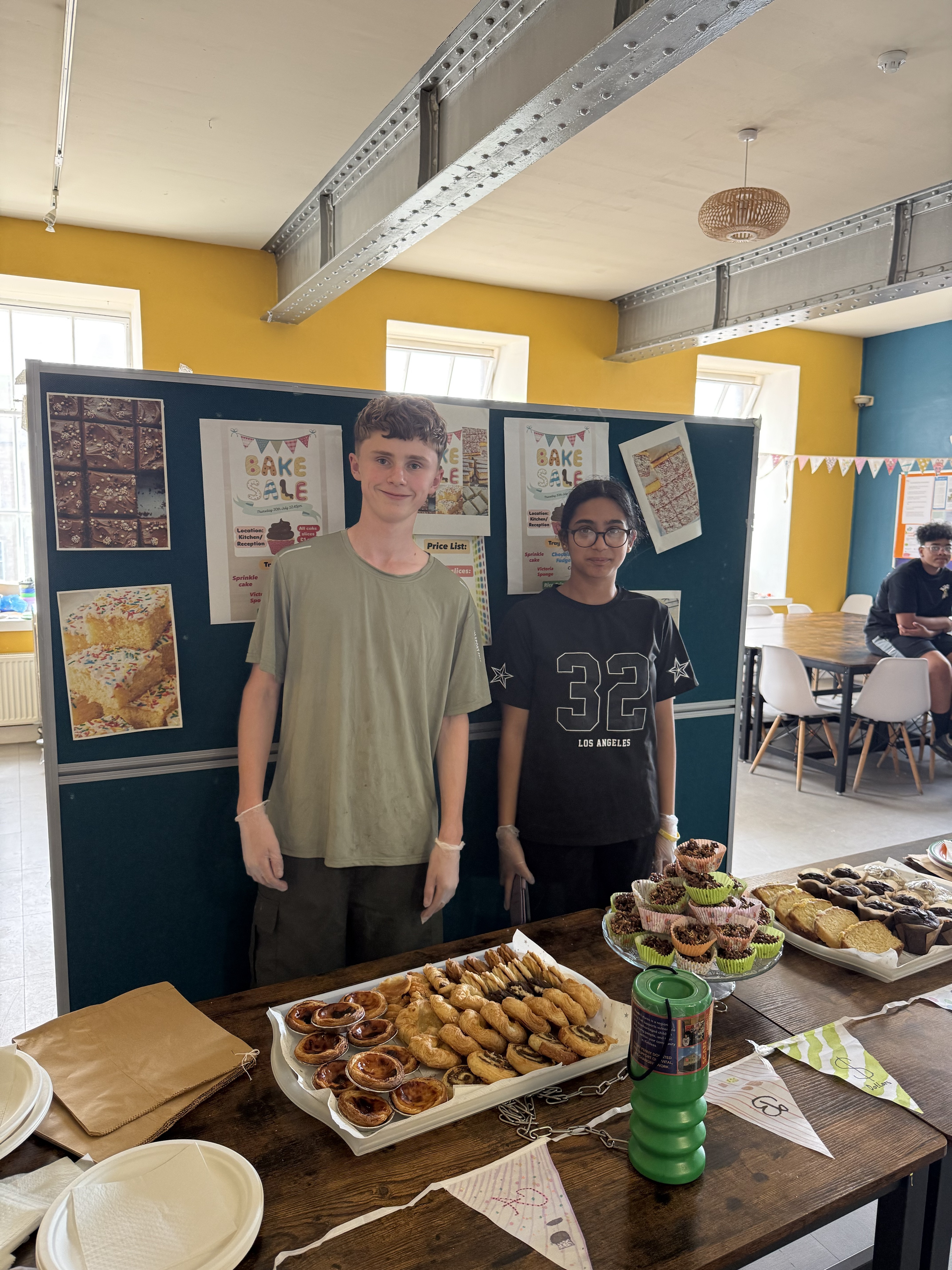 2 Out of school Club children at serving at bake sale