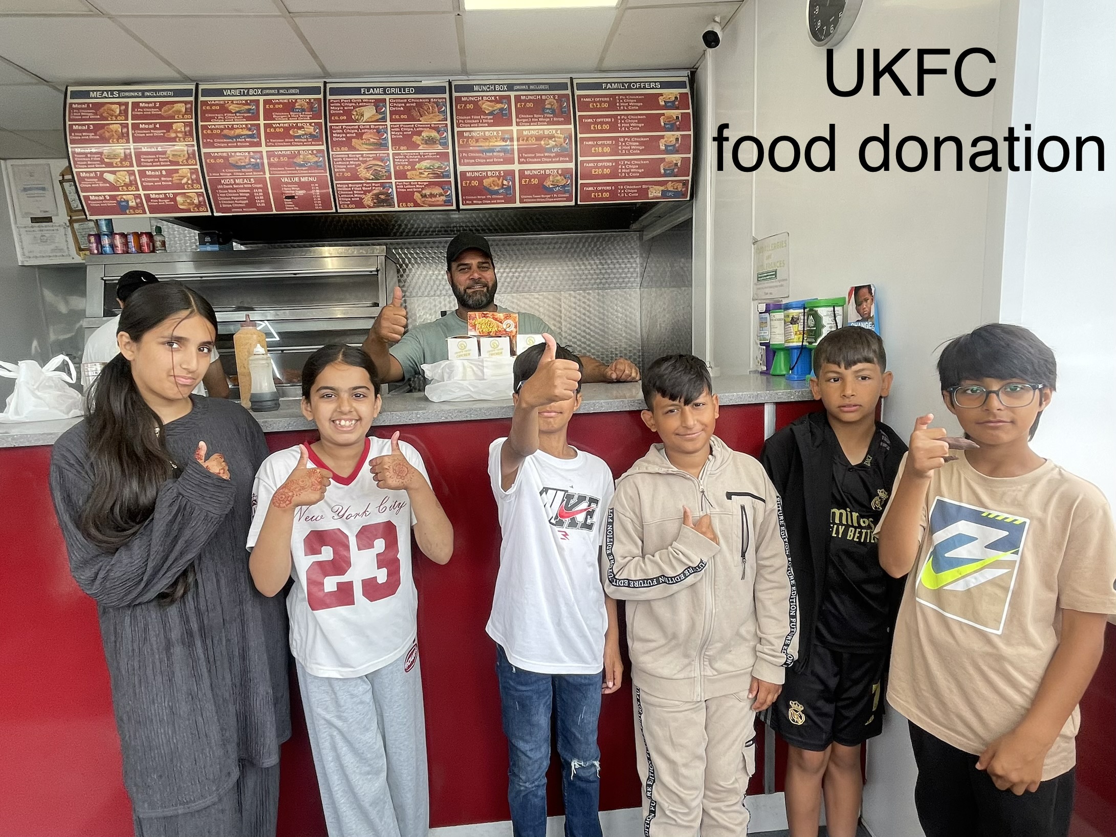 Haf children posing in UKFC shop in dewsbury which donated food
