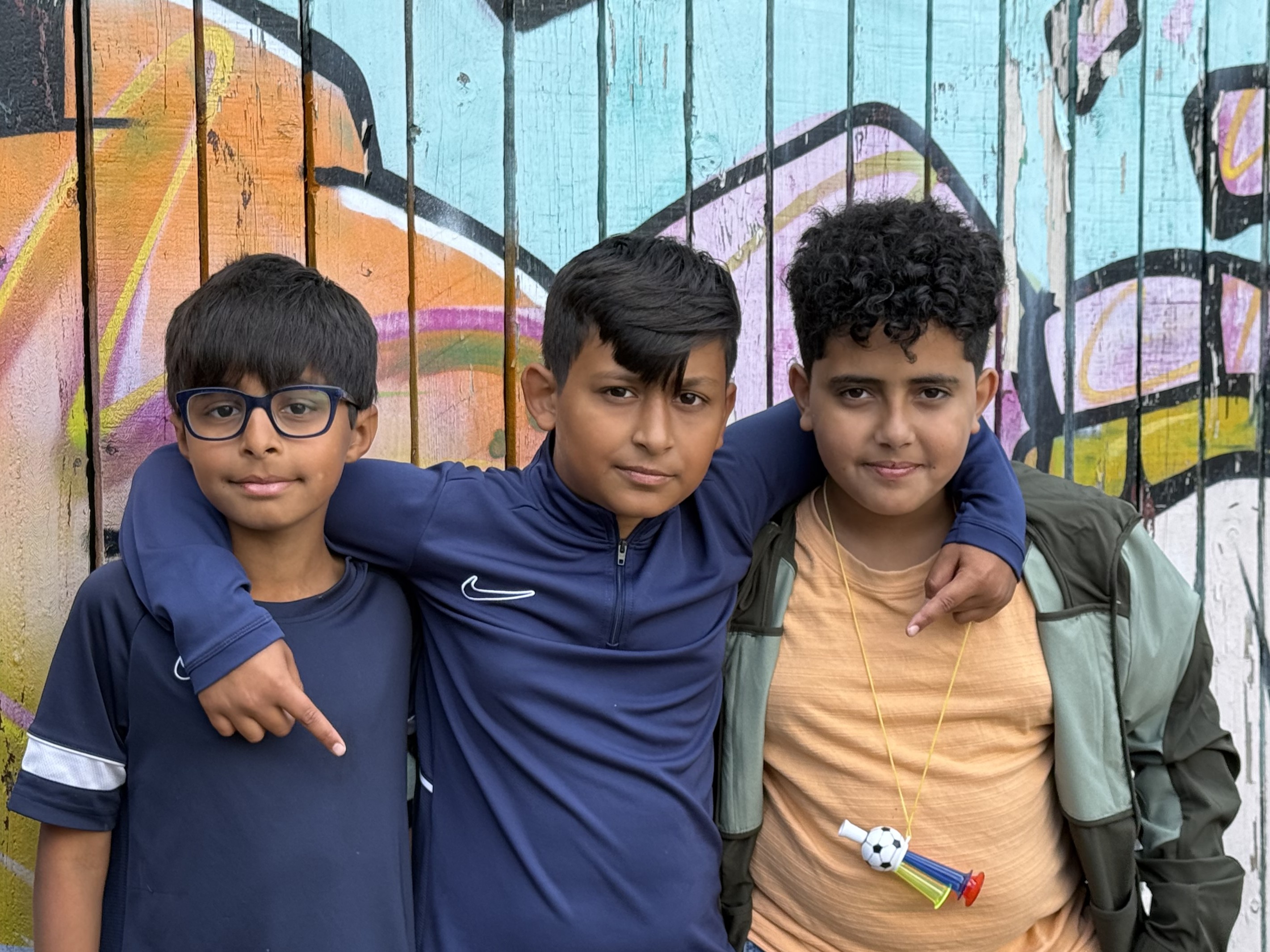 picture of 3 smiling boys at haf out of school club