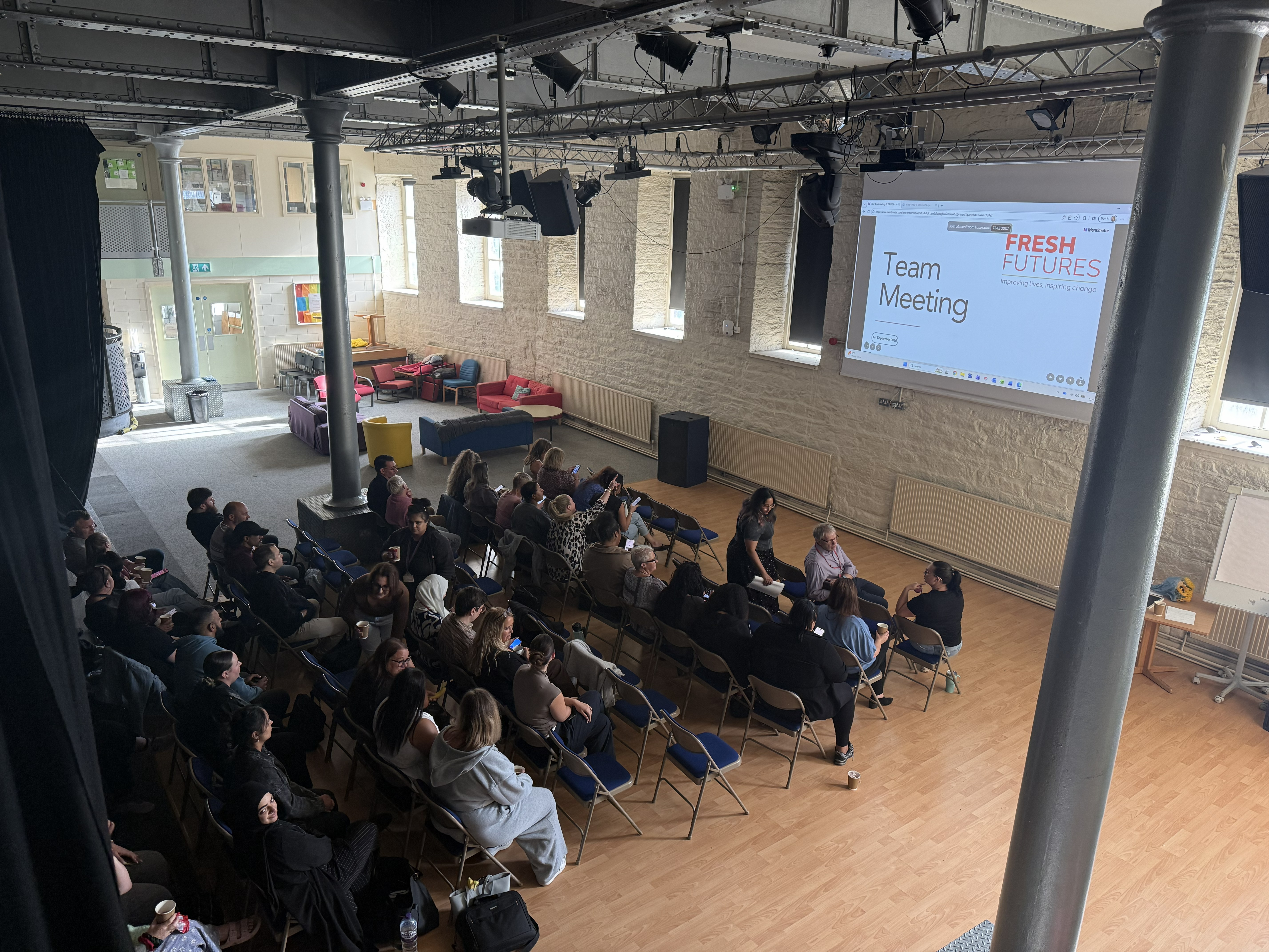 picture from a high angle of Fresh Furute and Brian Jackson College during One Team meeting